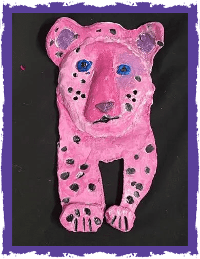 A pink leopard is made out of paper mache.