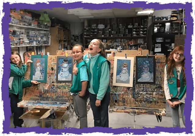 Two young girls in front of a painting.