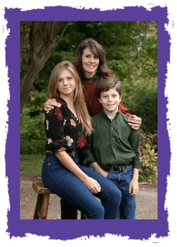 A woman and two children pose for the camera.