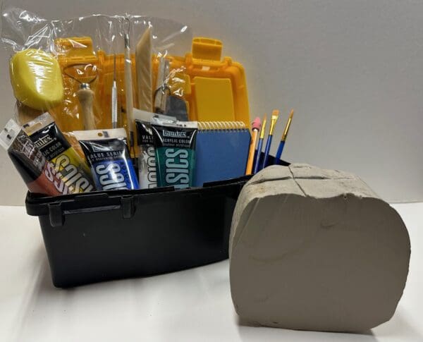 A basket of school supplies sitting next to a box.