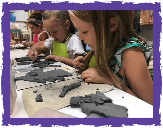 A group of children making clay animals.